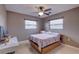 Bright bedroom with window blinds, ceiling fan, and wood-framed bed at 5117 6Th Avenue W Dr, Bradenton, FL 34209