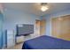 Bedroom with large TV, ocean mural, and double dresser at 5117 6Th Avenue W Dr, Bradenton, FL 34209