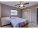 Bedroom featuring a ceiling fan, dresser, and sliding door closet at 5117 6Th Avenue W Dr, Bradenton, FL 34209