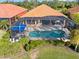 Aerial view of home with a screened pool and lanai at 5133 Cantabria Crst, Sarasota, FL 34238