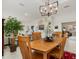 Light and airy dining room with a wooden table and seating for four at 5133 Cantabria Crst, Sarasota, FL 34238