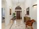 Bright and airy entryway with tile floors and elegant chandelier at 5133 Cantabria Crst, Sarasota, FL 34238