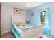 Bedroom with light wood furniture, and blue and white bedding at 5375 Joslyn Ter, Port Charlotte, FL 33981