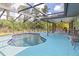 Inviting kidney-shaped pool with screened enclosure and patio at 5375 Joslyn Ter, Port Charlotte, FL 33981