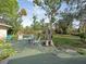 Backyard wooden deck features an umbrella and seating arrangement offering an ideal outdoor leisure spot at 5411 9Th E St, Bradenton, FL 34203