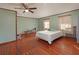 A spacious bedroom featuring decorative wood flooring, a ceiling fan and natural light at 5411 9Th E St, Bradenton, FL 34203