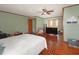 A bedroom with decorative wood flooring, a ceiling fan, and a large television at 5411 9Th E St, Bradenton, FL 34203