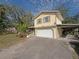 Two-story home with a two-car garage and attached carport on a sunny day at 5411 9Th E St, Bradenton, FL 34203