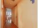 Hallway with a door leading to a bedroom, displaying classic wood trim and hardwood floors at 5411 9Th E St, Bradenton, FL 34203