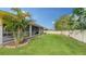 Landscaped backyard with palm trees at 5687 Milton Ave, Sarasota, FL 34243