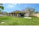 Backyard view showing home, patio, and fenced yard at 5687 Milton Ave, Sarasota, FL 34243