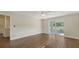 Bright bedroom with wood-look tile floors and sliding glass doors to patio at 5687 Milton Ave, Sarasota, FL 34243