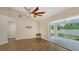 Dining room with hardwood floors, ceiling fan and access to patio at 5687 Milton Ave, Sarasota, FL 34243