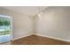 Bright dining room with hardwood floors and sliding glass doors at 5687 Milton Ave, Sarasota, FL 34243