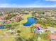 Aerial view of community with golf course and lake at 6170 Misty Oaks Dr, Sarasota, FL 34243