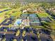 Aerial view of community tennis courts, pool, and parking at 6170 Misty Oaks Dr, Sarasota, FL 34243