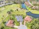 Aerial view of two homes and a golf course at 6170 Misty Oaks Dr, Sarasota, FL 34243