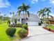 Bright and airy home with manicured lawn and palm trees at 6170 Misty Oaks Dr, Sarasota, FL 34243