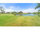 Peaceful view of a golf course and serene lake at 6170 Misty Oaks Dr, Sarasota, FL 34243