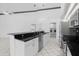 Modern kitchen with stainless steel appliances and black countertops at 6170 Misty Oaks Dr, Sarasota, FL 34243