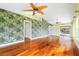 Living room with hardwood floors and tropical-themed wallpaper at 6170 Misty Oaks Dr, Sarasota, FL 34243