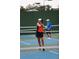 Resident playing pickleball on community court at 6170 Misty Oaks Dr, Sarasota, FL 34243