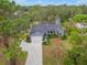 Aerial view of house with a driveway and large yard at 6207 93Rd Street E Cir, Bradenton, FL 34202