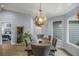 Elegant dining room with wood table, gray chairs, and large windows at 6207 93Rd Street E Cir, Bradenton, FL 34202