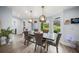 Modern dining room with wood table, gray chairs, and view to backyard at 6207 93Rd Street E Cir, Bradenton, FL 34202