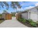 Side view of house with wooden gate and long driveway at 6207 93Rd Street E Cir, Bradenton, FL 34202