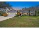 Gray house with a white garage door and landscaped yard at 6207 93Rd Street E Cir, Bradenton, FL 34202