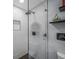 Modern shower with hexagon tile floor and glass enclosure at 6207 93Rd Street E Cir, Bradenton, FL 34202