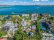 Aerial view of waterfront property, highlighting a tennis court and surrounding houses at 624 Norsota Way, Sarasota, FL 34242