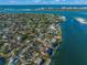 Aerial view of waterfront community, showcasing various houses and a tennis court at 624 Norsota Way, Sarasota, FL 34242