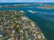 Aerial perspective of a residential area near the water, featuring a tennis court at 624 Norsota Way, Sarasota, FL 34242