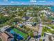 Aerial view of waterfront property with pool and tennis court at 624 Norsota Way, Sarasota, FL 34242