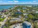 Aerial view showing a waterfront property with a tennis court and surrounding homes at 624 Norsota Way, Sarasota, FL 34242