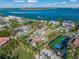 Aerial view of waterfront property with pool and tennis court at 624 Norsota Way, Sarasota, FL 34242