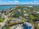 Aerial view of waterfront property with pool and tennis court at 624 Norsota Way, Sarasota, FL 34242