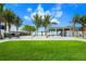 Beachfront lawn with palm trees and a view of the ocean at 624 Norsota Way, Sarasota, FL 34242