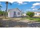 Small white house with blue shutters and walkway at 624 Norsota Way, Sarasota, FL 34242