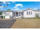 White house with screened porch and gravel driveway at 624 Norsota Way, Sarasota, FL 34242