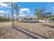 White bungalow with screened porch and mature palm trees at 624 Norsota Way, Sarasota, FL 34242