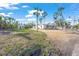 House with palm trees, gravel driveway and a guest house at 624 Norsota Way, Sarasota, FL 34242