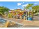 Outdoor seating area with patio umbrellas and tropical plants at 624 Norsota Way, Sarasota, FL 34242