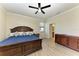 Primary bedroom with large bed, wood flooring, and ceiling fan at 6512 Willowshire Way, Bradenton, FL 34212