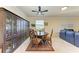 Elegant dining area with a round table, dark wood chairs, and a large cabinet at 6512 Willowshire Way, Bradenton, FL 34212