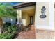 Front entry with brick walkway, stone accents, and a stylish door at 6512 Willowshire Way, Bradenton, FL 34212