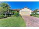 Single-story house with a brick driveway and well-manicured lawn at 6512 Willowshire Way, Bradenton, FL 34212