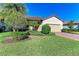 Single-story house with tile roof, landscaping, and paver driveway at 6512 Willowshire Way, Bradenton, FL 34212